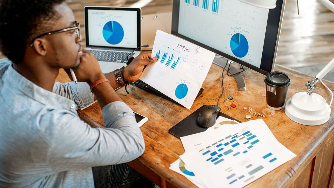 man sitting around the table and viewing analytics data