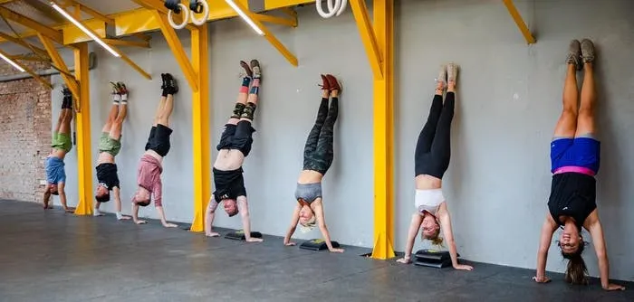 Members of CrossFit Tay Ho doing handstands