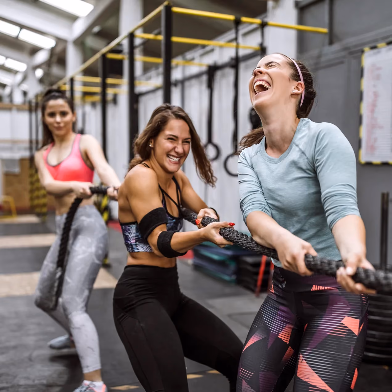 3 women pulling a rope