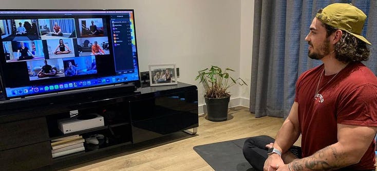 A personal trainer leads a session from his living room. | Photo Credit: Luke Sumner-Wilson