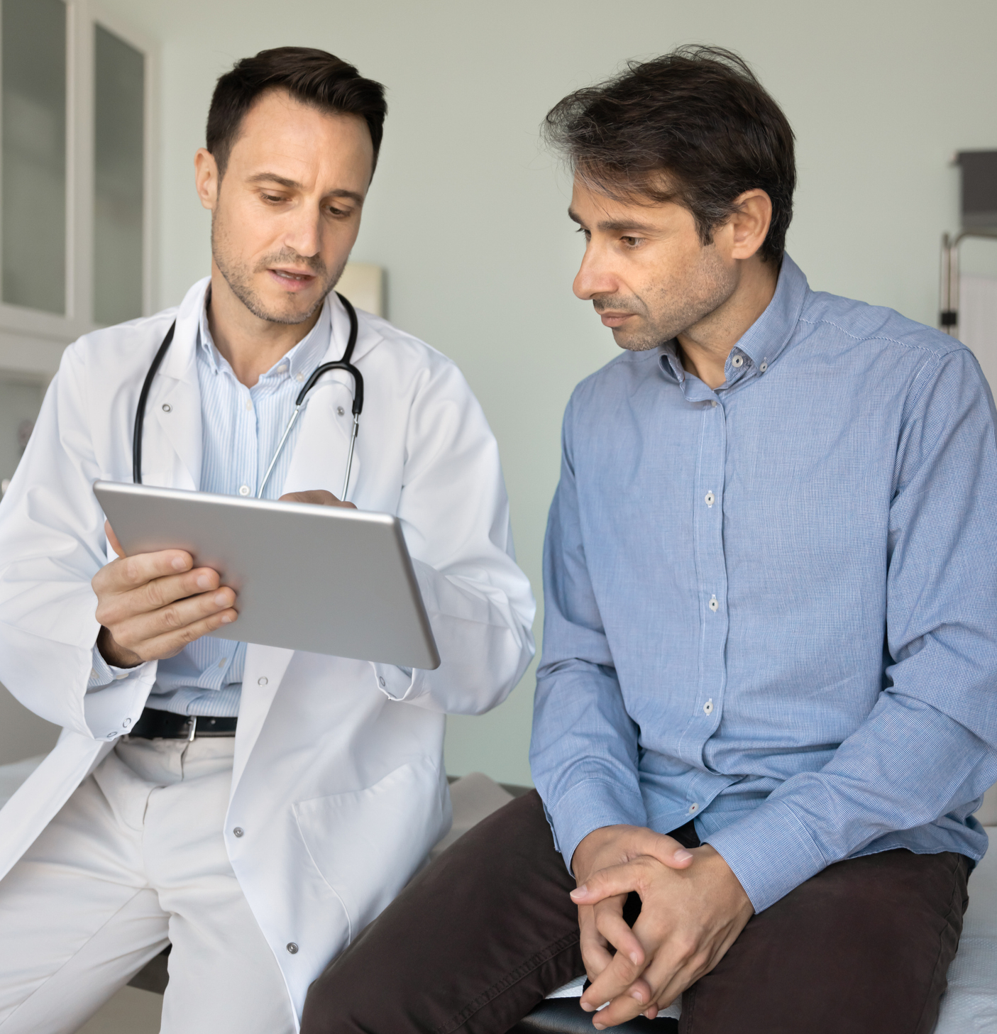 Cardiologist reviewing health information with a patient during a consultation