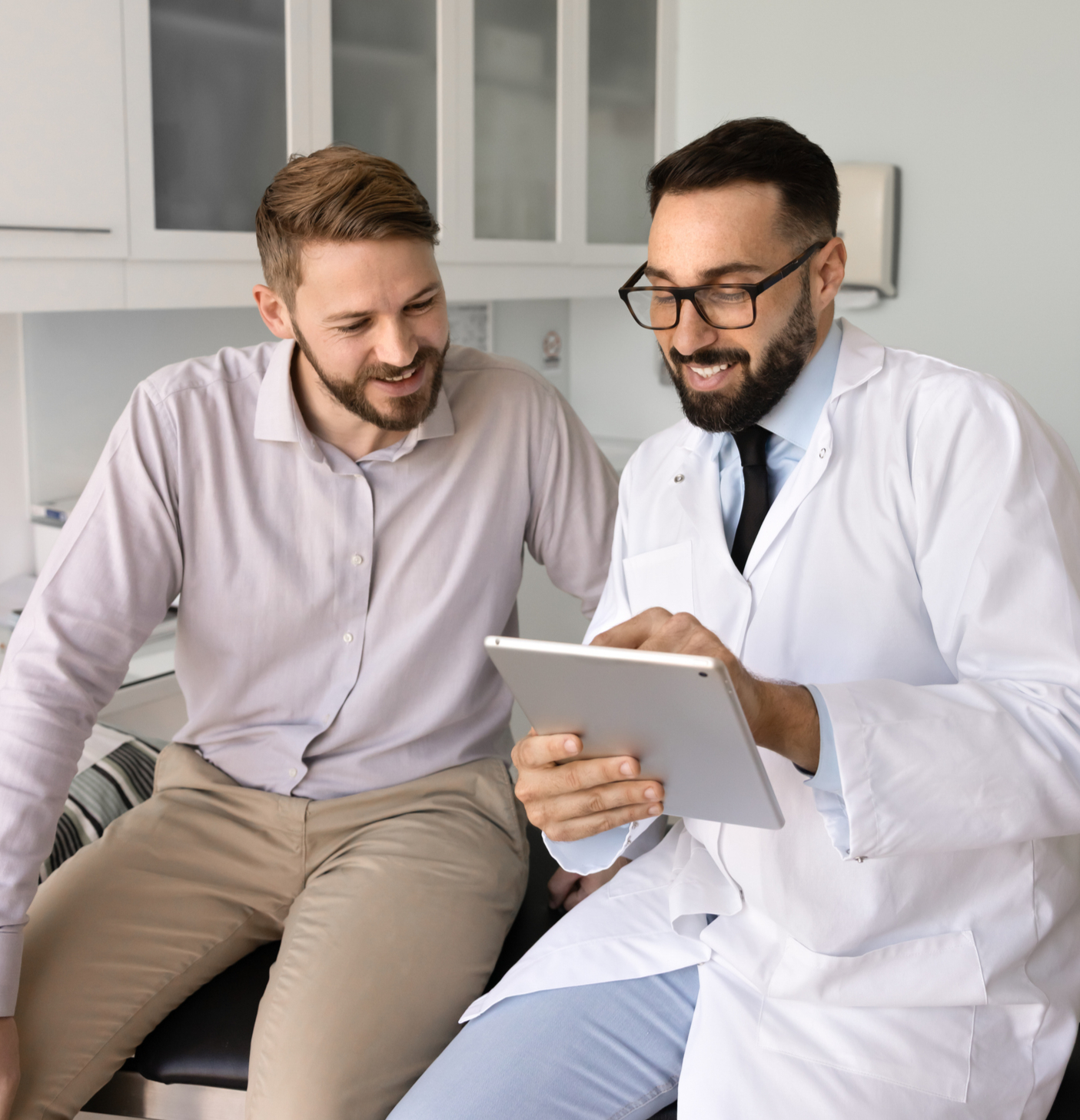 Doctor reviewing patient information on a tablet during a healthcare consultation
