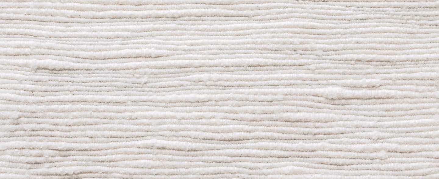 Close-up of beige textured fabric with horizontal ridges and soft, plush surface.
