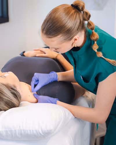 Dr. Ashley wearing green scrubs and dry needling a patient.
