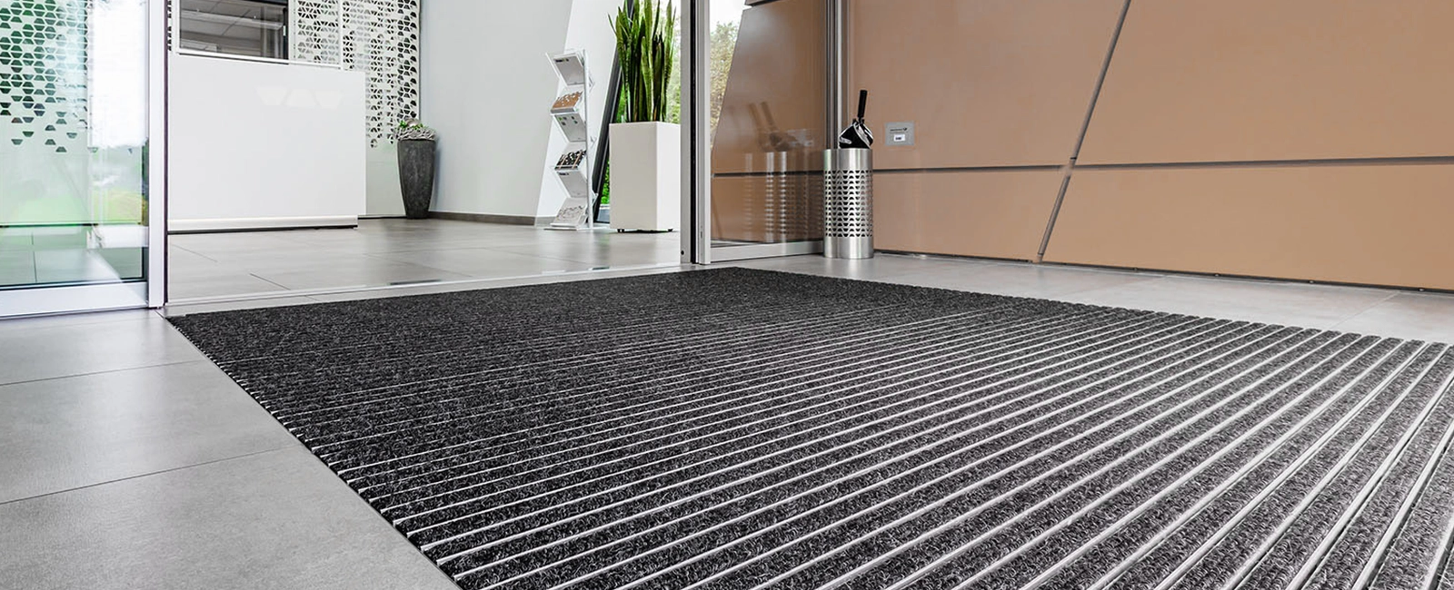 Recessed EMCO entrance mat with anthracite ribbed carpet insert in a reception area