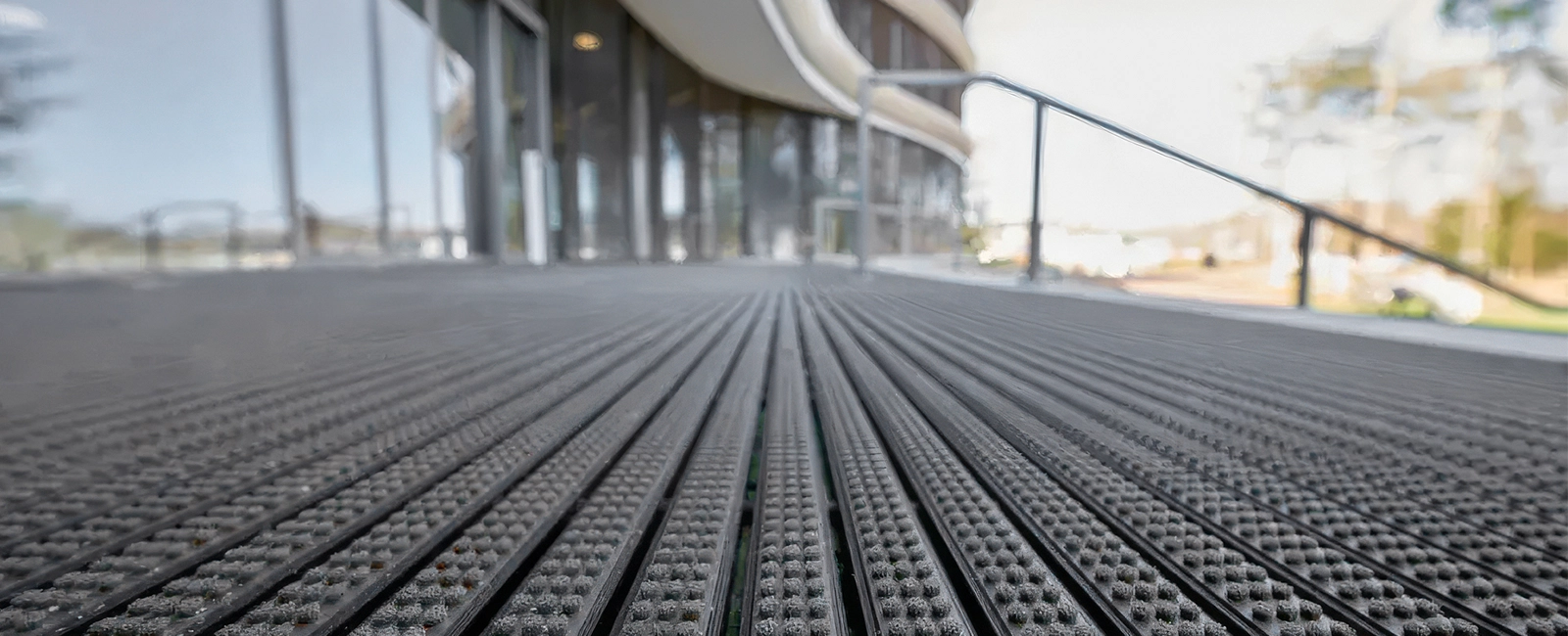 Close-up of EMCO aluminum profiles with black rubber inserts at an outdoor entrance