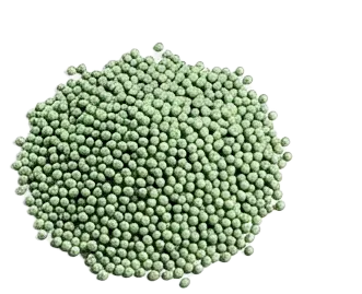 Cluster of small green spherical beads or pellets on a plain white background.