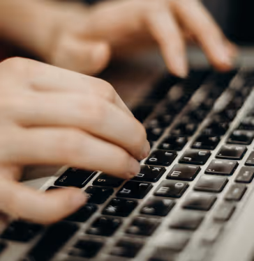 A person typing on their keyboard