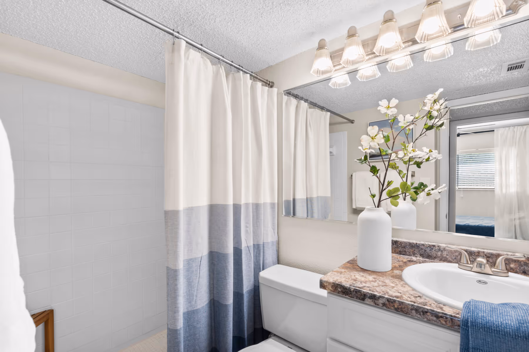 Bathroom with vanity and shower tub combo with shower curtain