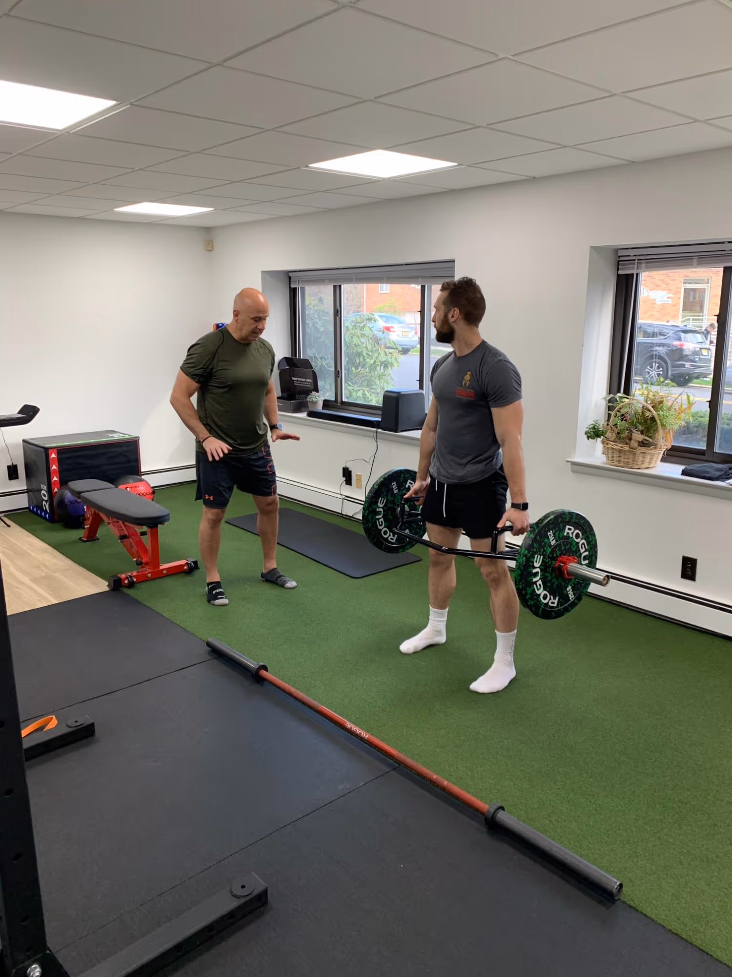 Dr. John Puzio demonstrating a lift with a client at Ethos Physical Therapy in Hackensack, NJ.