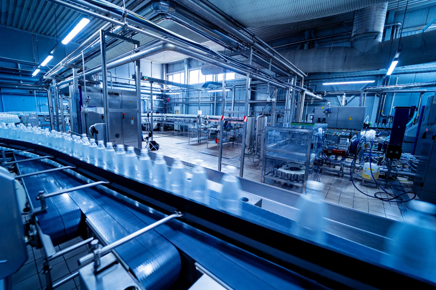 A bottling line running inside a beverage production plant.