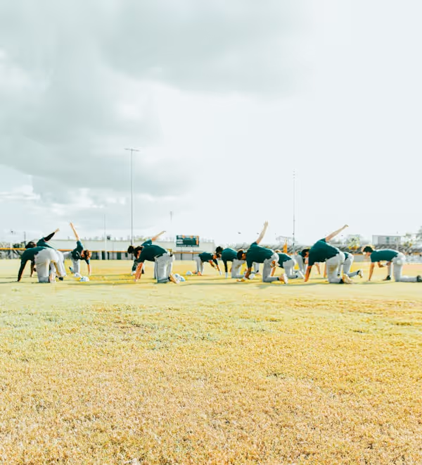 a group of baseball players standing on top of a field