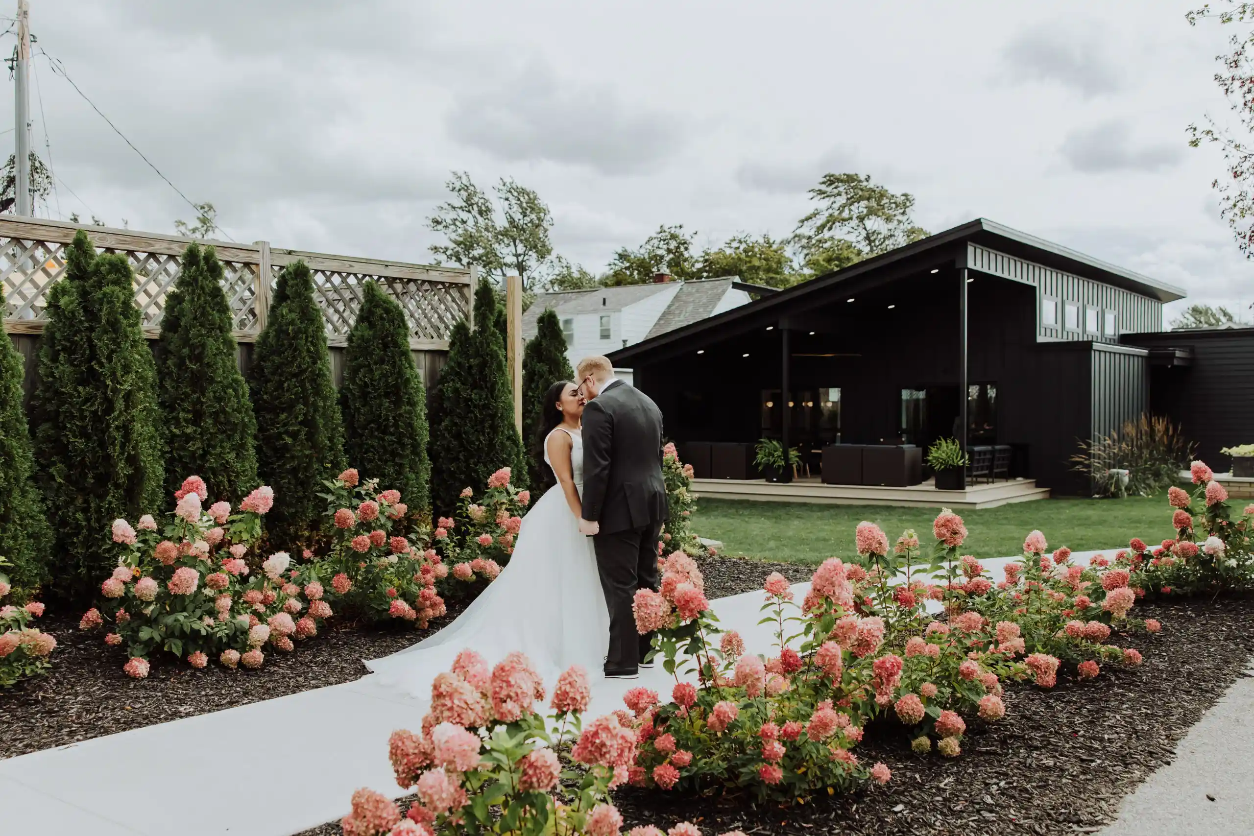 newly wed couple in front of the cove house at port 393, weddings and events in holland michigan