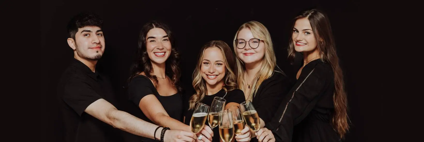 Team members at port 393 cheersing champagne