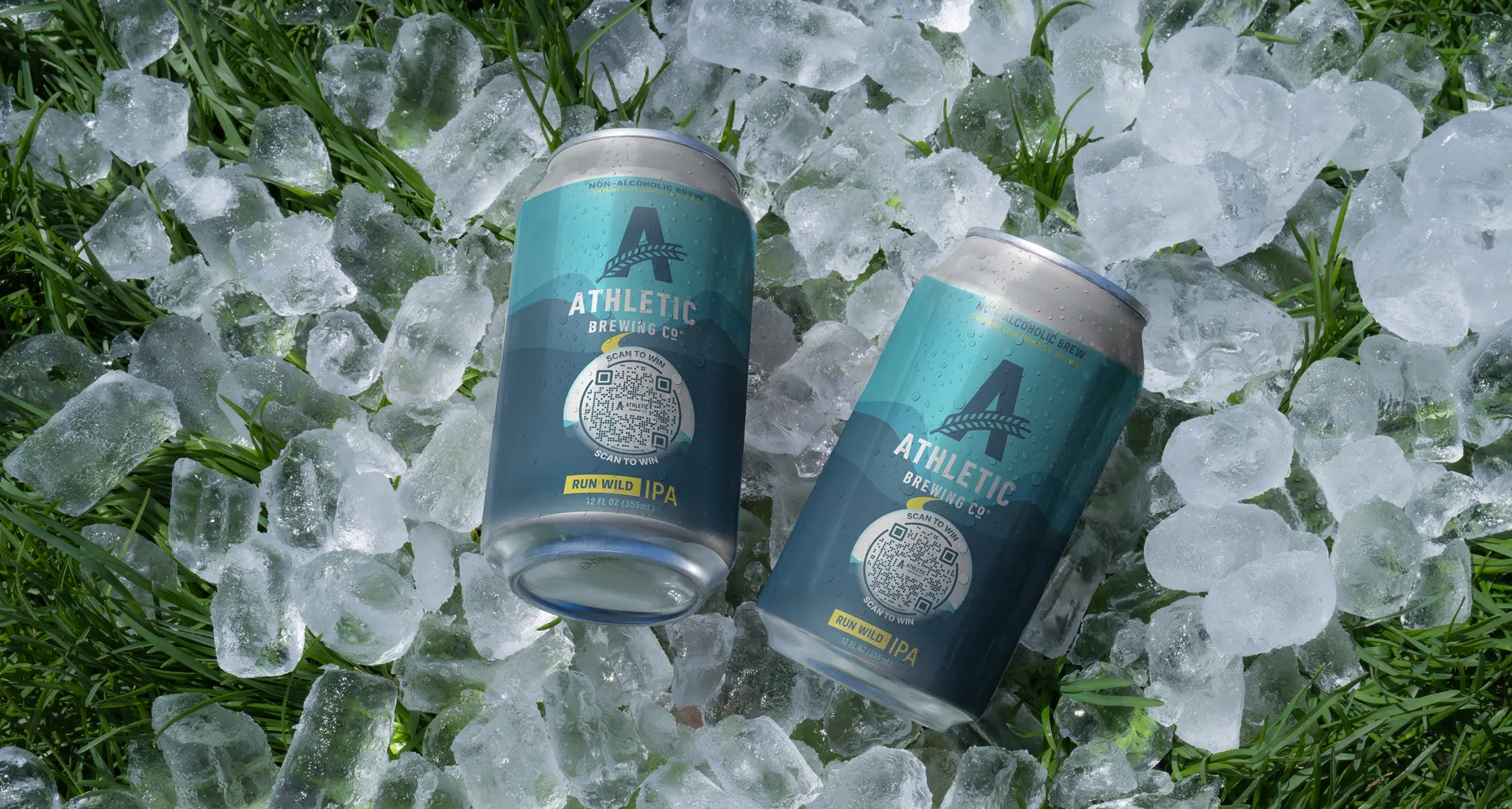 Two cans of Athletic Brewing Co Run Wild IPA with Flowcodes on ice over grass.