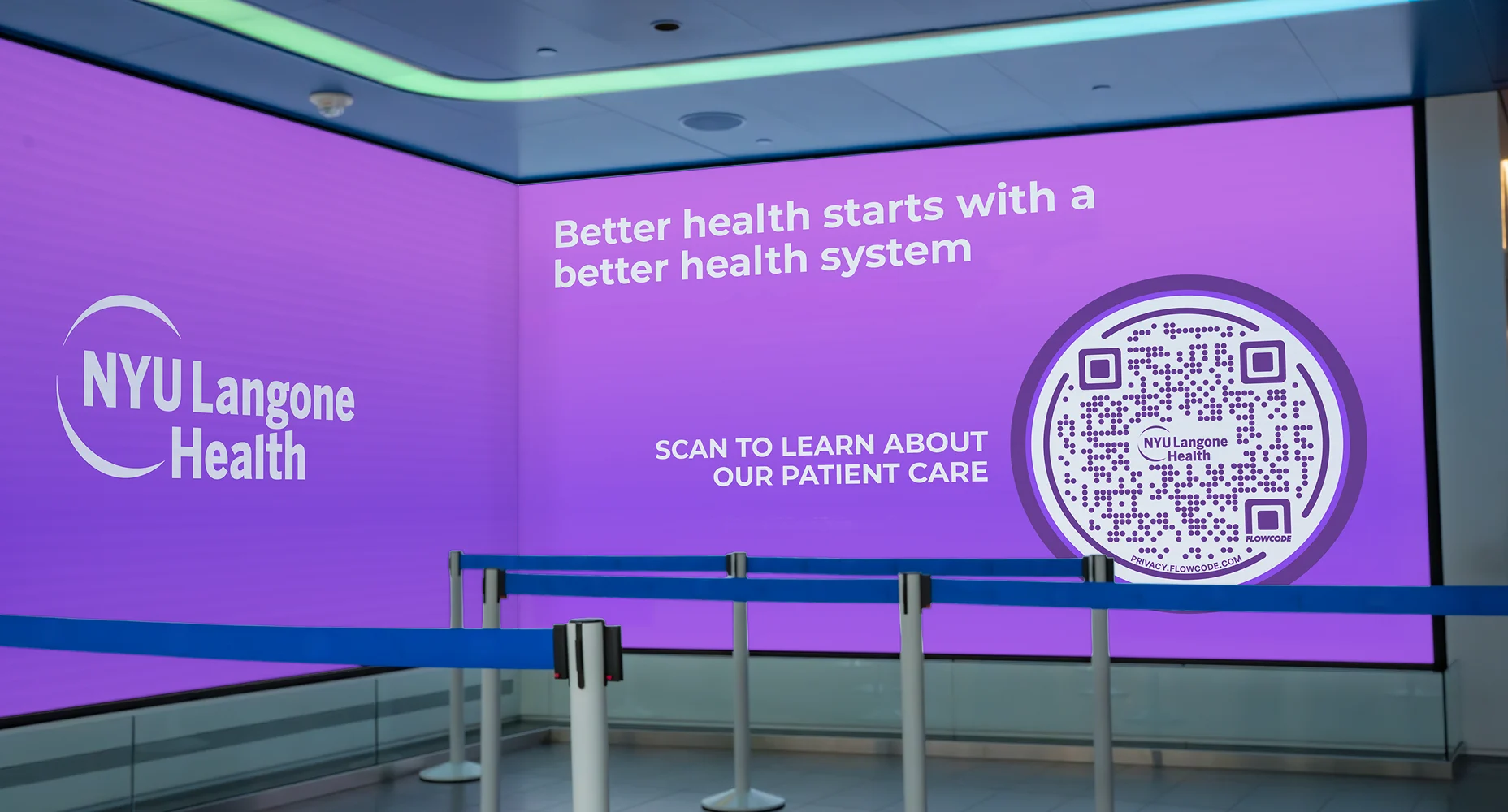 Purple digital display with NYU Langone Health logo, a Flowcode, and text about improving health through better care.