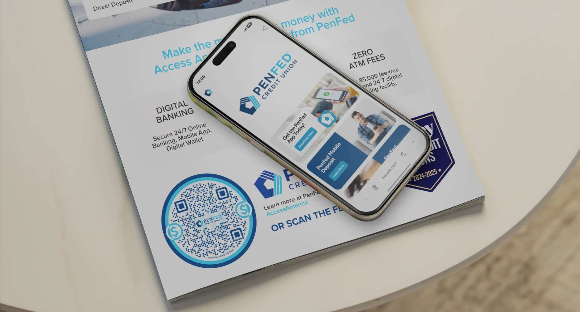 Smartphone displaying PenFed Credit Union FlowHub on a brochure promoting digital banking and zero ATM fees with a Flowcode.