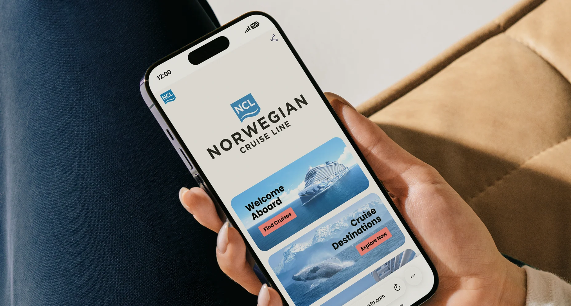 Hand holding a smartphone displaying Norwegian Cruise Line FlowHub with options to find cruises and explore destinations.