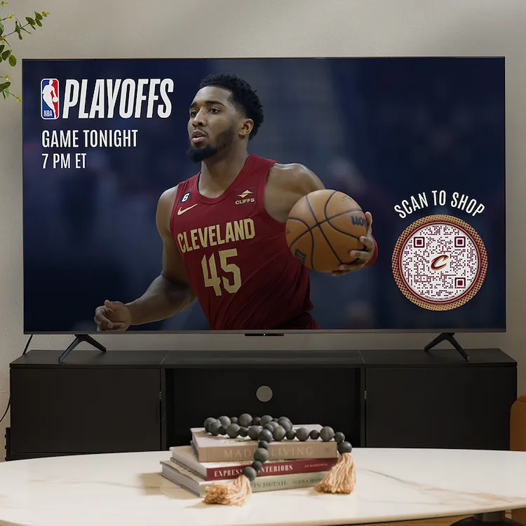 A TV showing Donovan Mitchell from the Cavs for NBA Playoffs commercial with a Scan to Shop Flowcode.