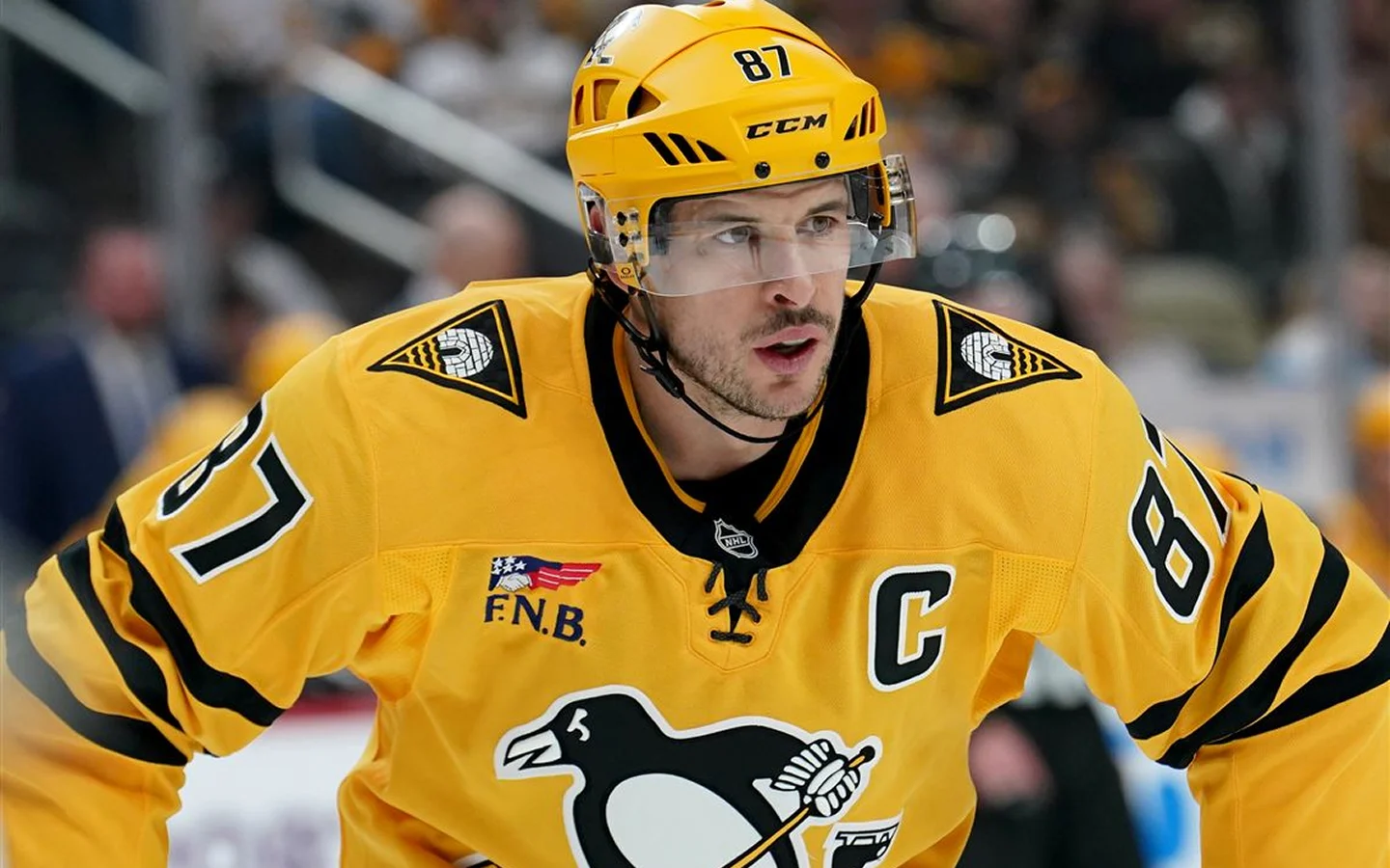 Pittsburgh Penguins captain in yellow alternate jersey during an NHL game at PPG Paints Arena
