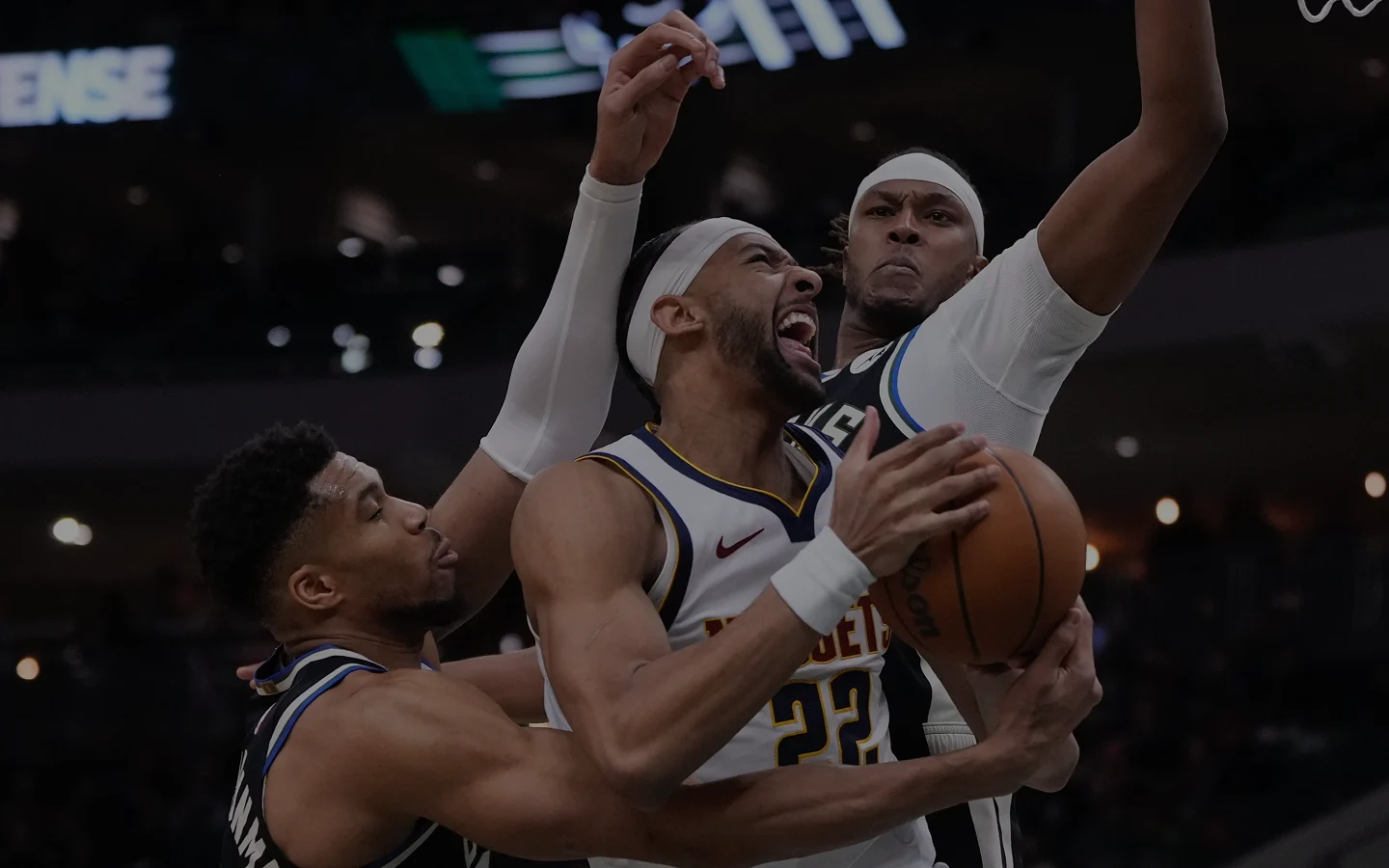 Milwaukee Bucks defender contests a drive during an NBA game at Fiserv Forum