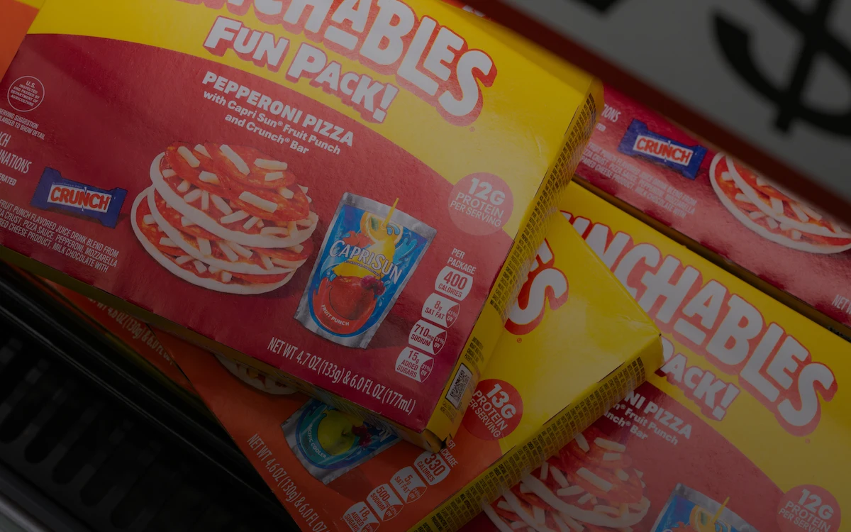 Four boxes of Lunchables Fun Pack Pepperoni Pizza fill a freezer drawer.