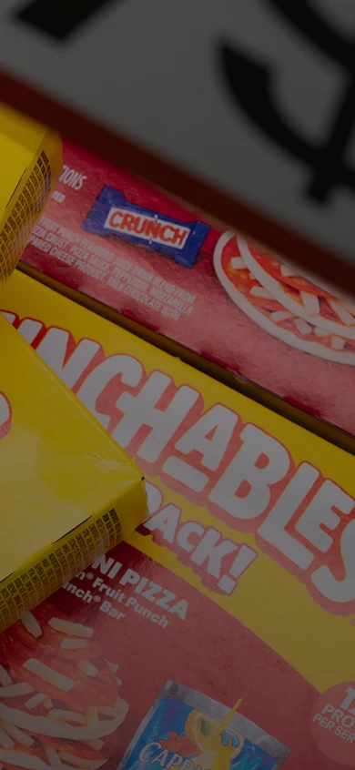 Four boxes of Lunchables Fun Pack Pepperoni Pizza fill a freezer drawer.
