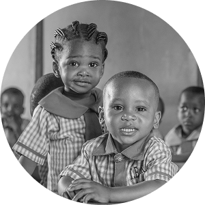 Black-and-white photo of two smiling children at school