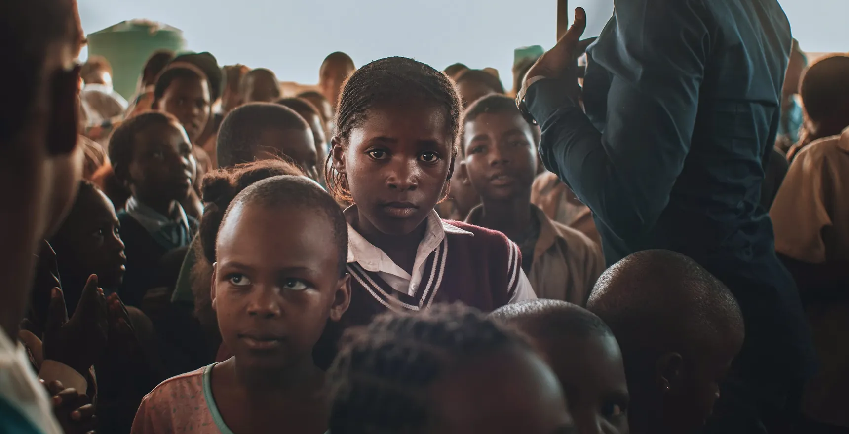 Group of children gathered together outdoors in a community setting