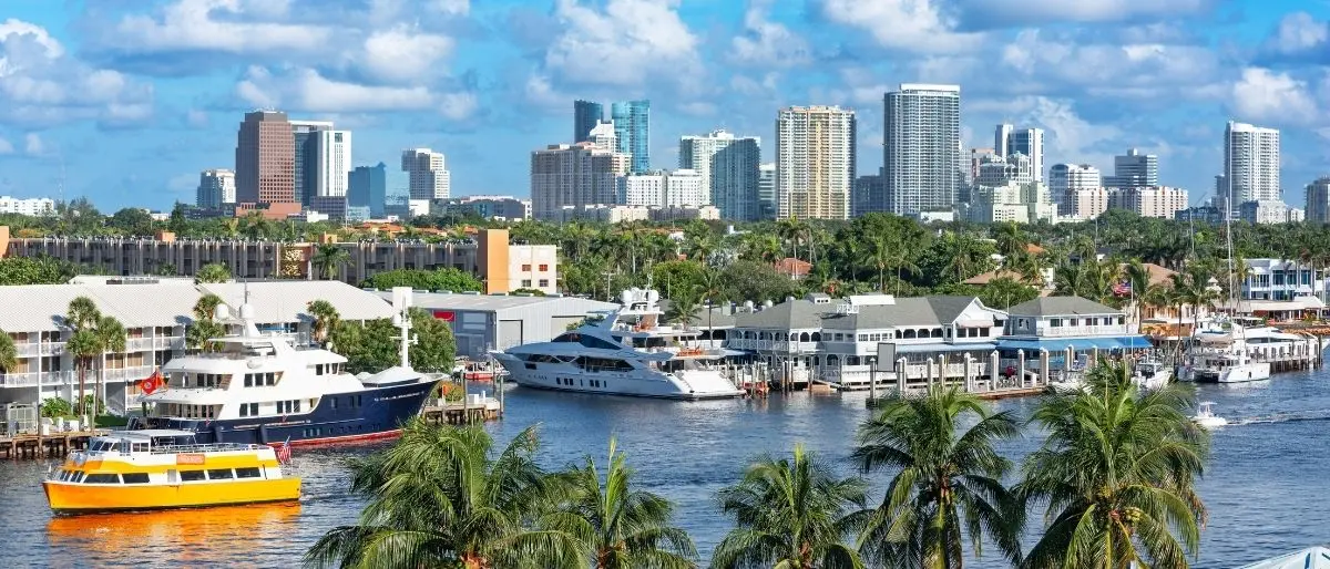new construction condos South Florida waterfront skyline, condo floor plans and pricing comparison document, buyer reviewing pre construction contract Florida