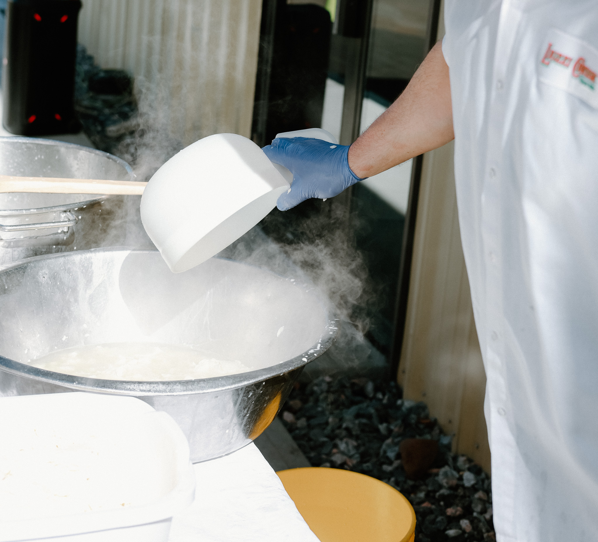 Person making fresh mozzarella.