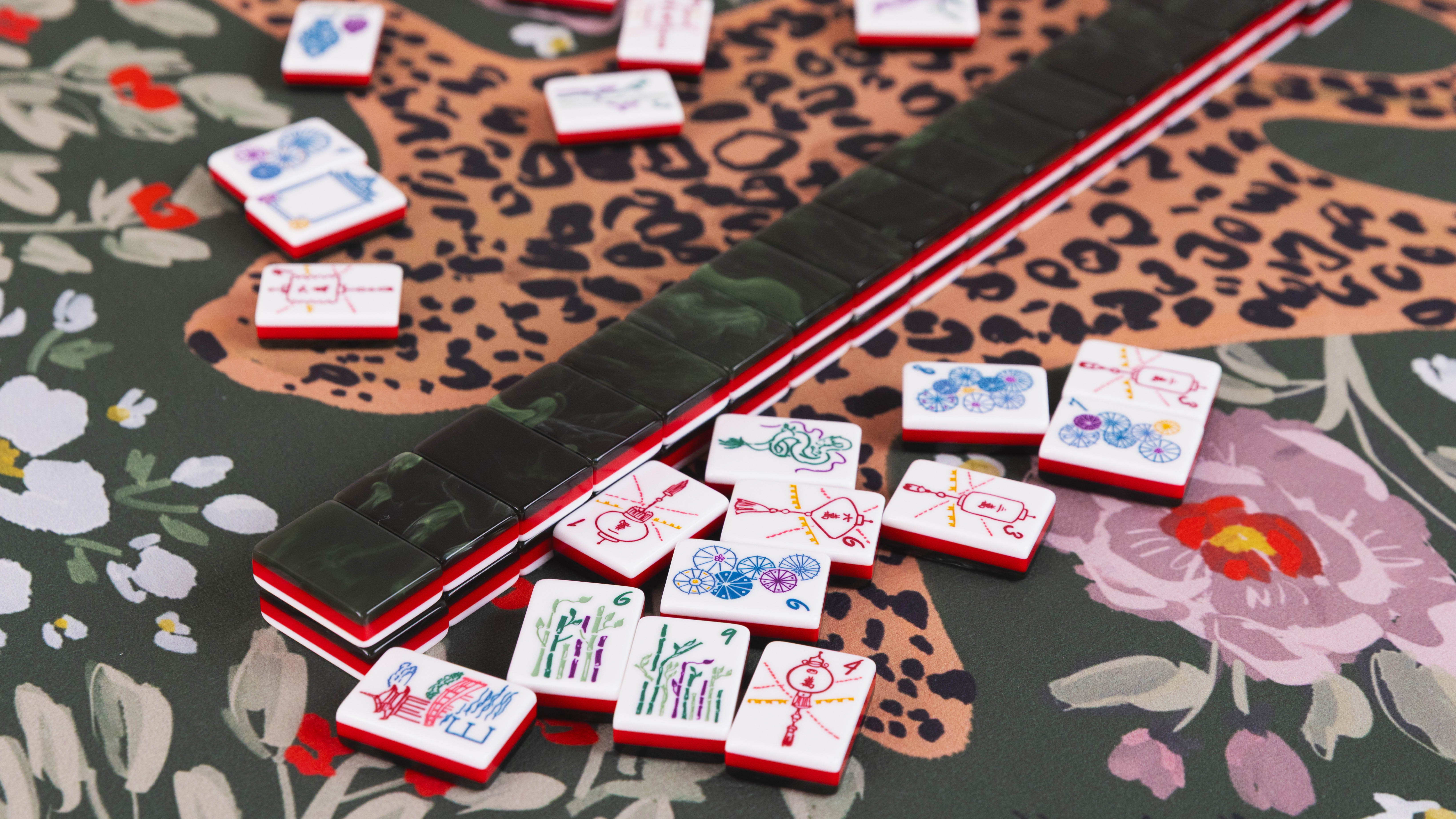 Mahjong tiles arranged on a leopard print mat
