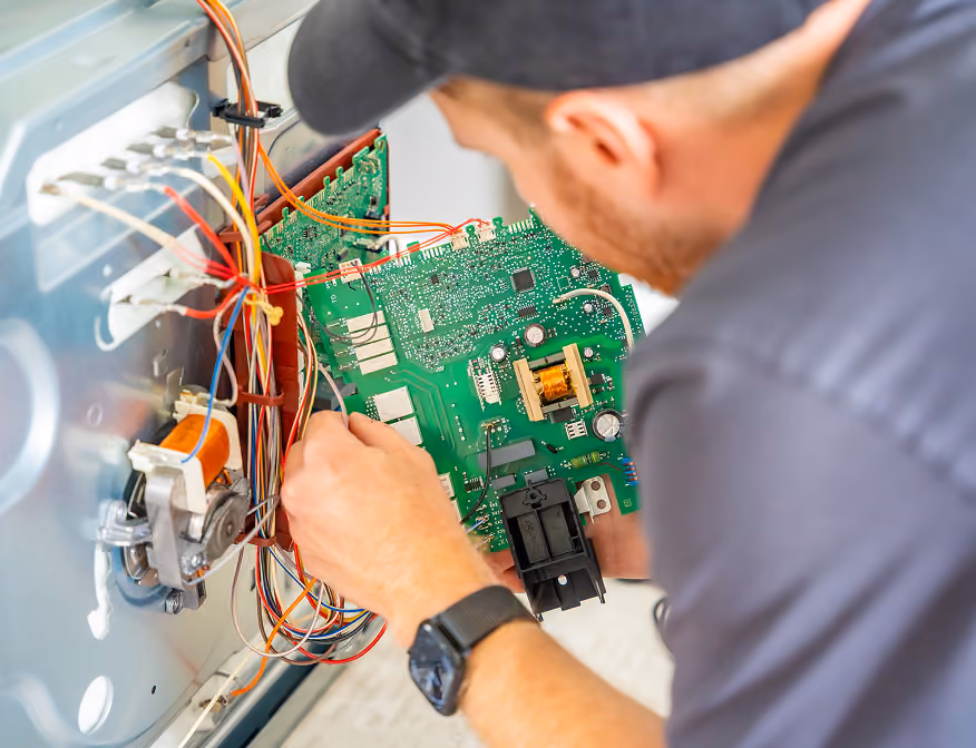 Electrical equipment installer assembling and testing electrical equipment for a clean energy project in California.