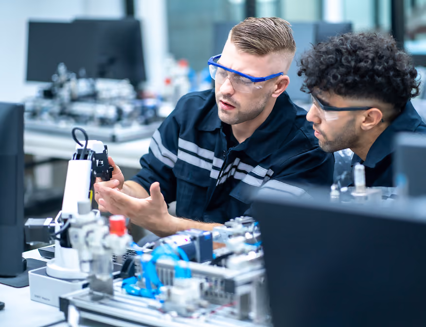 Two mechanical engineering technologists inspecting mechanical components for energy systems.