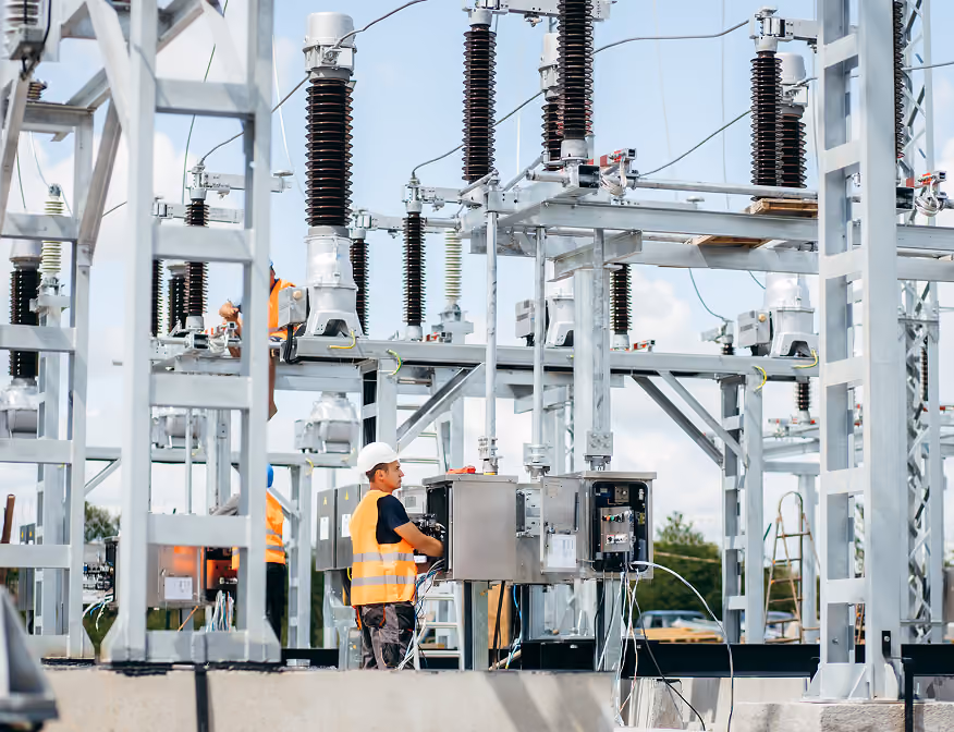 Substation technician performing maintenance on high-voltage electrical systems.