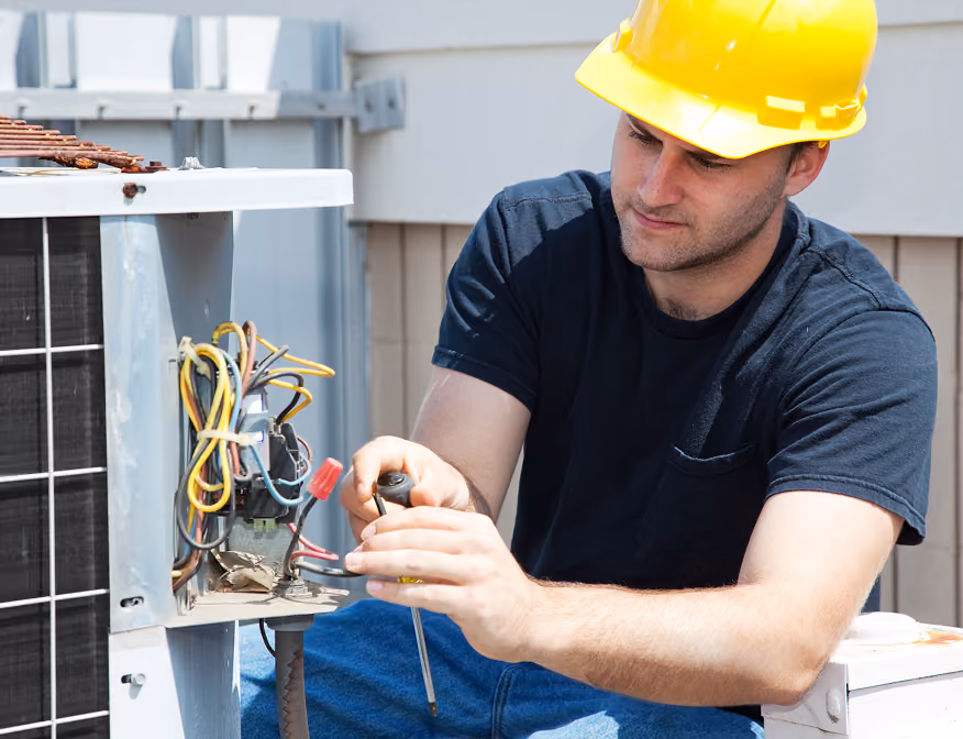 Man working with HVAC equipment in a training program for HVAC technician careers.