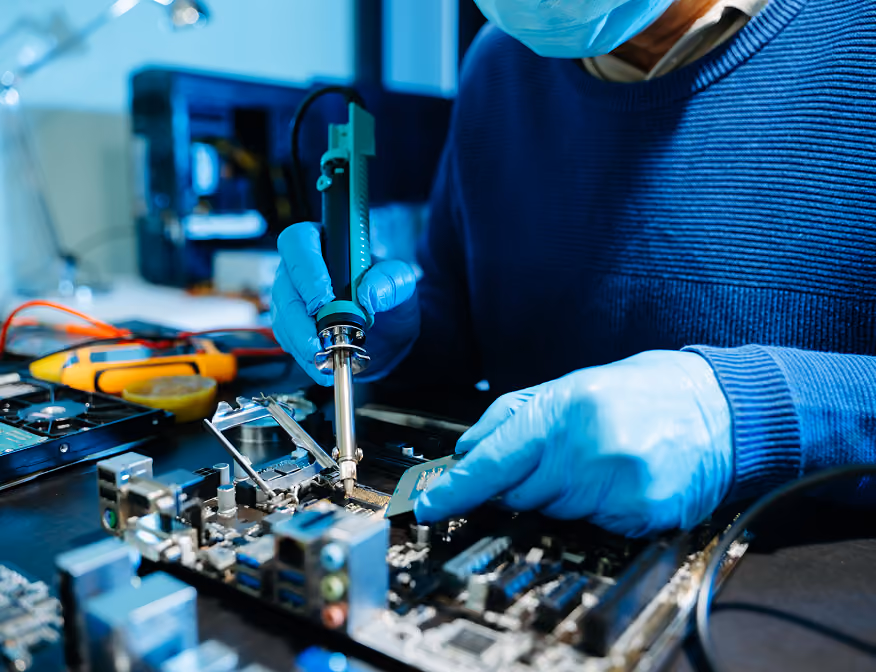 Electronic engineering technologist testing electrical equipment in a laboratory setting.