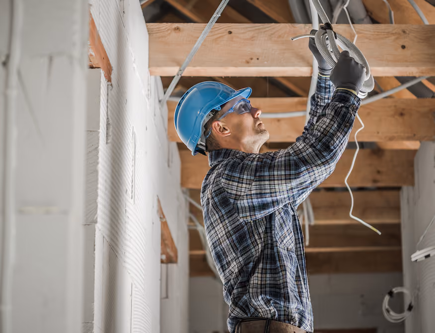 Skilled electrician working on electrical infrastructure job that supports clean energy development in the Inland region.