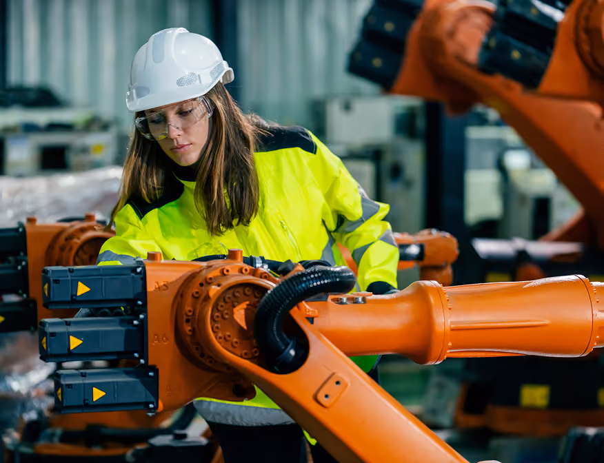 Industrial machinery mechanic performing maintenance on large industrial systems.