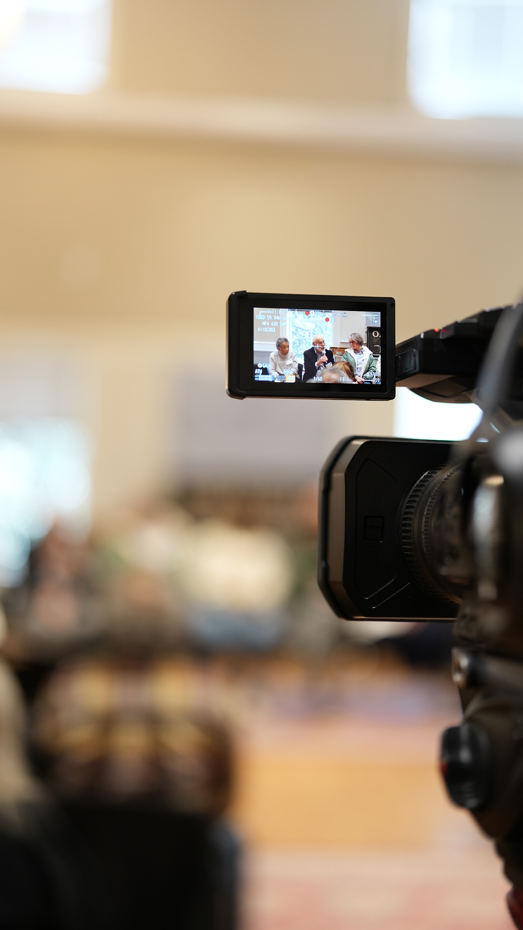 A camera's display shows several speakers at an event in Oak Bluffs