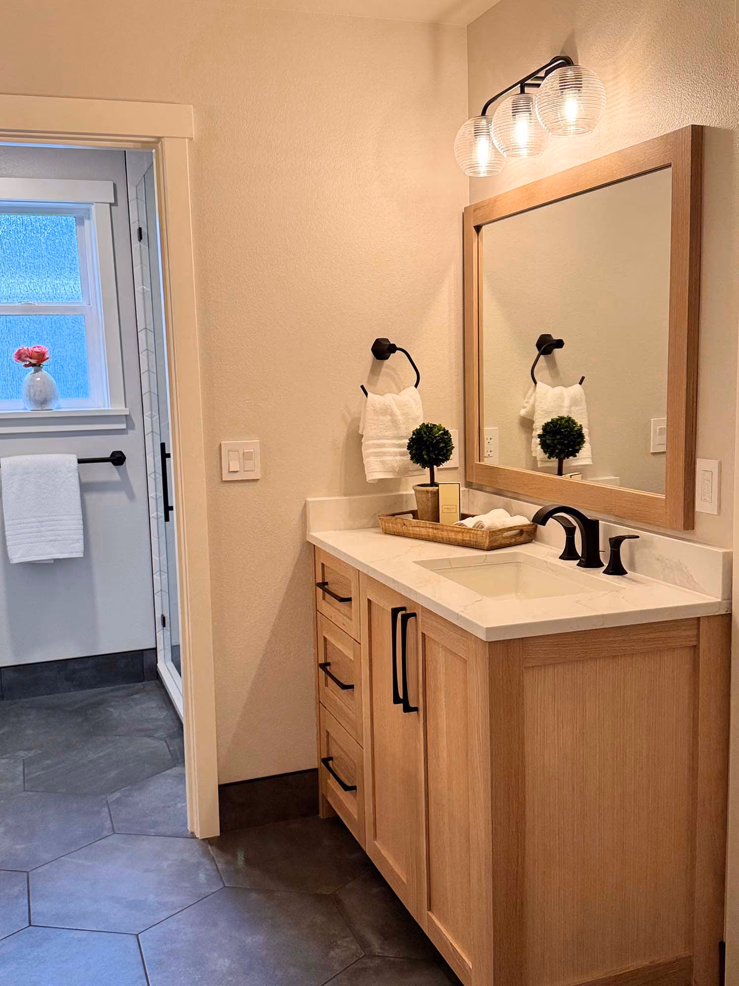 Bathroom vanity with wood cabinet and round mirror