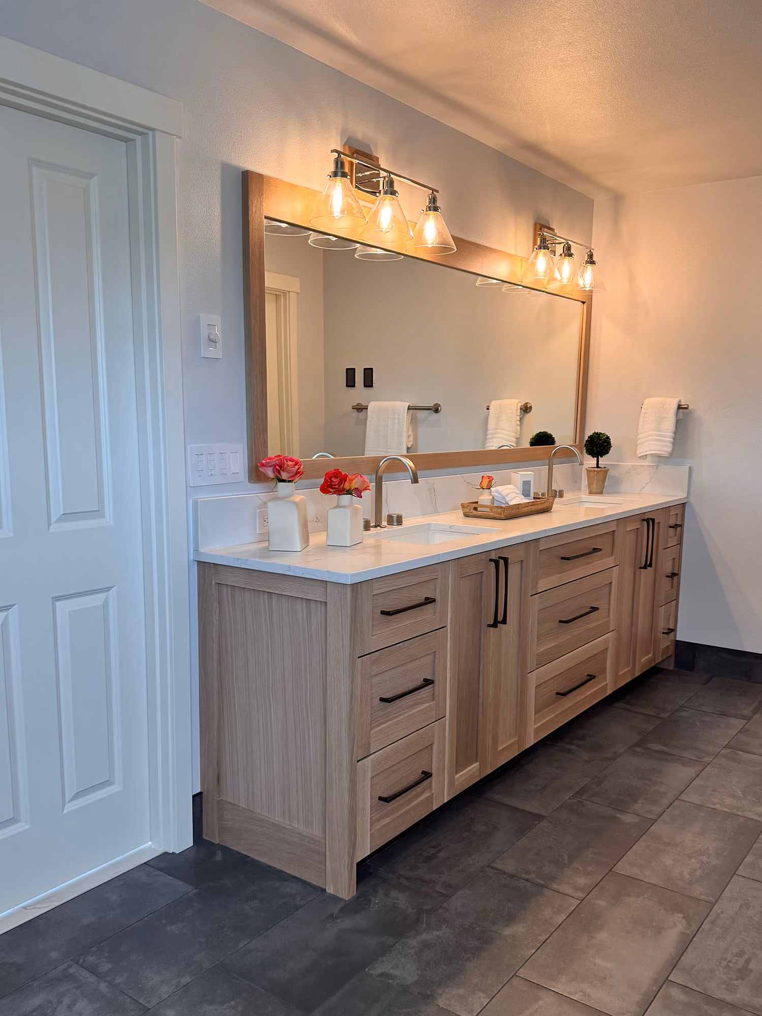 Bright bathroom vanity with double sinks and wall lights