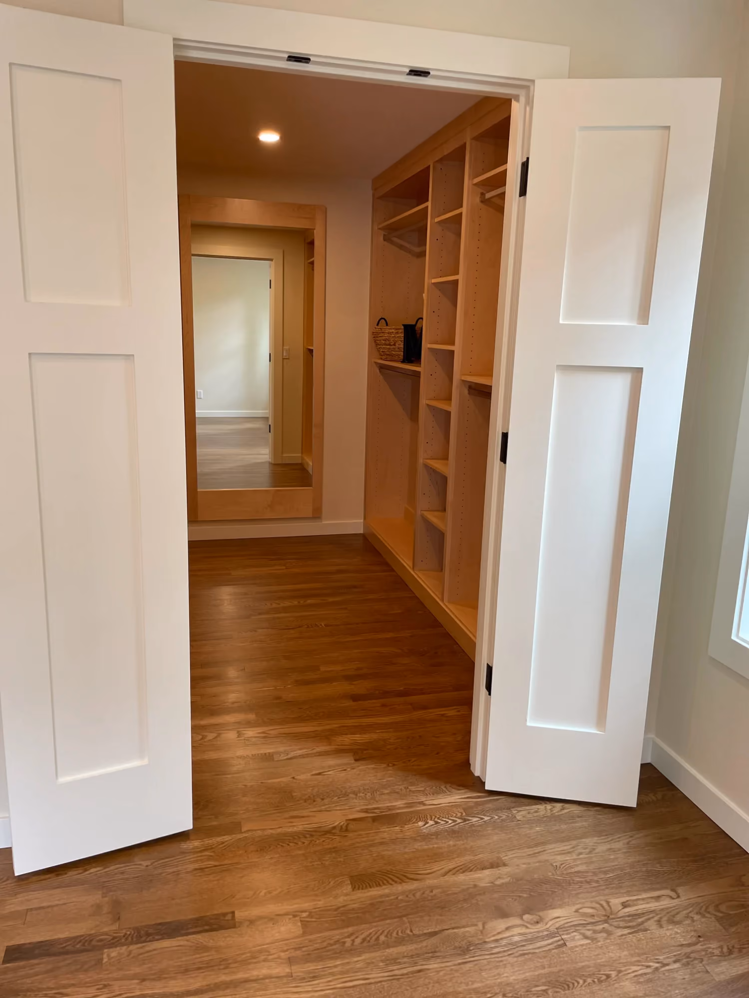 Entryway showing a staircase and hardwood floors