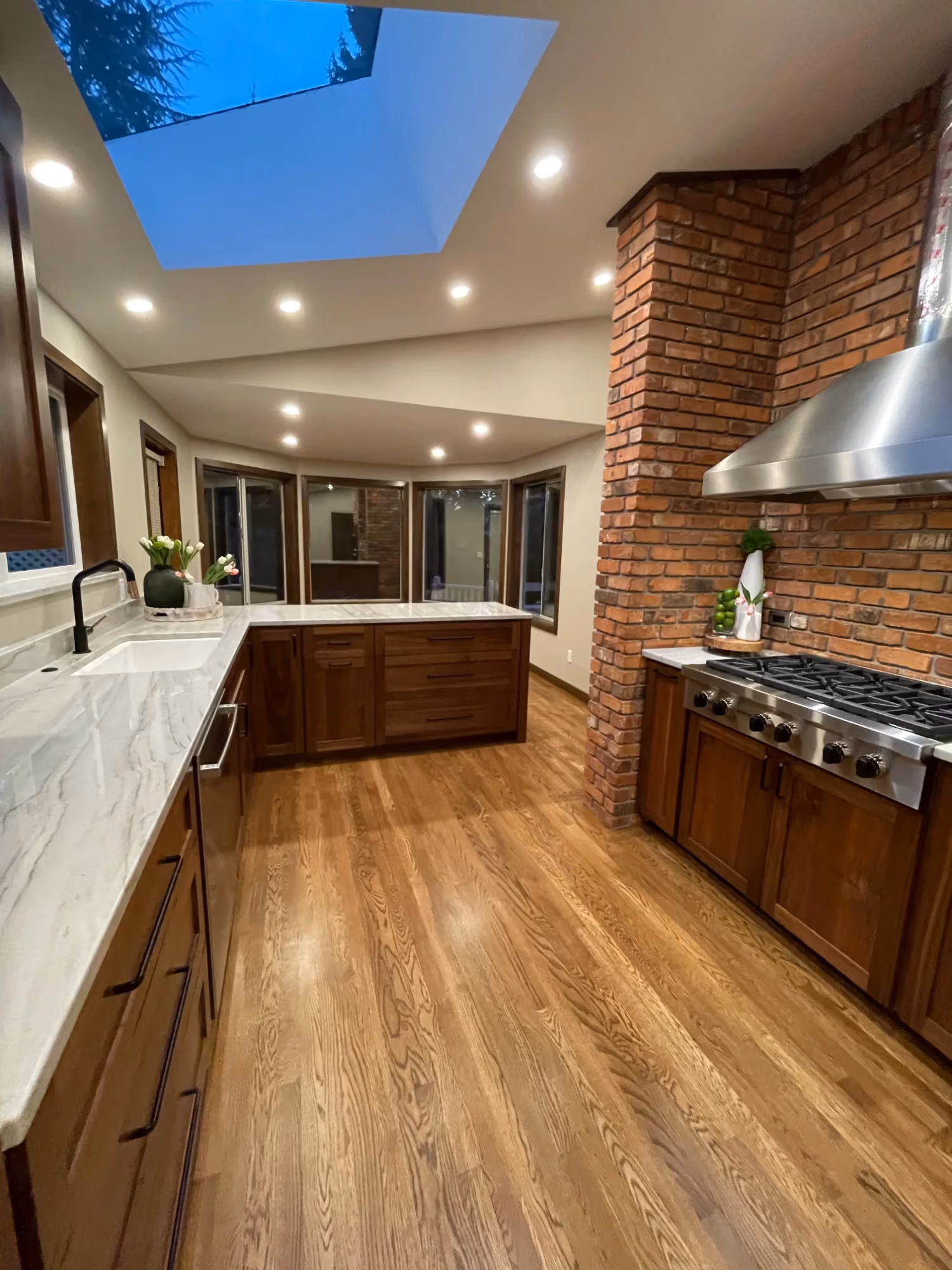 Kitchen with wood cabinets, island, and hardwood floors