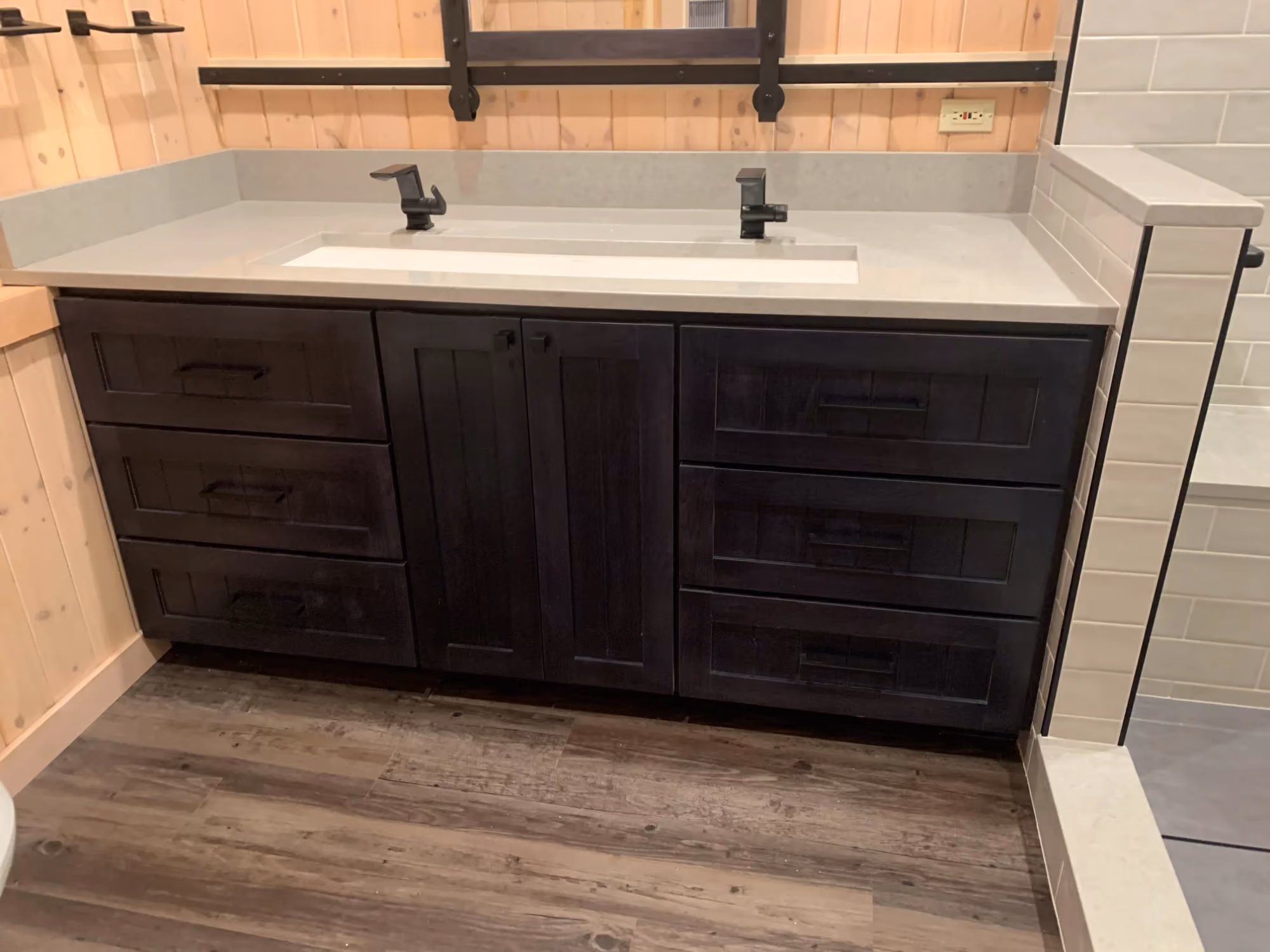 Double-sink vanity with dark wood cabinets and white countertop