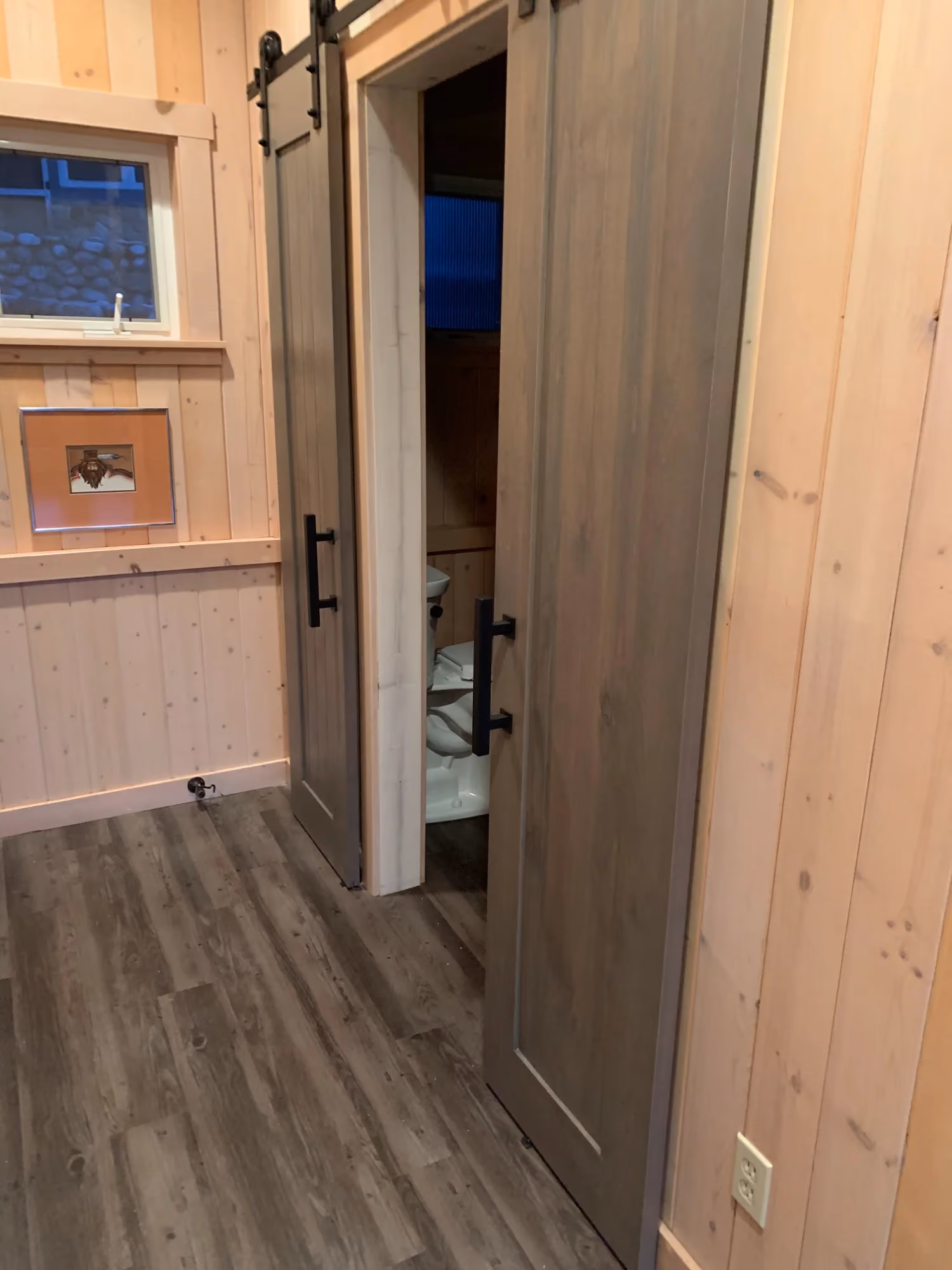 Hallway with wooden barn door and black hardware