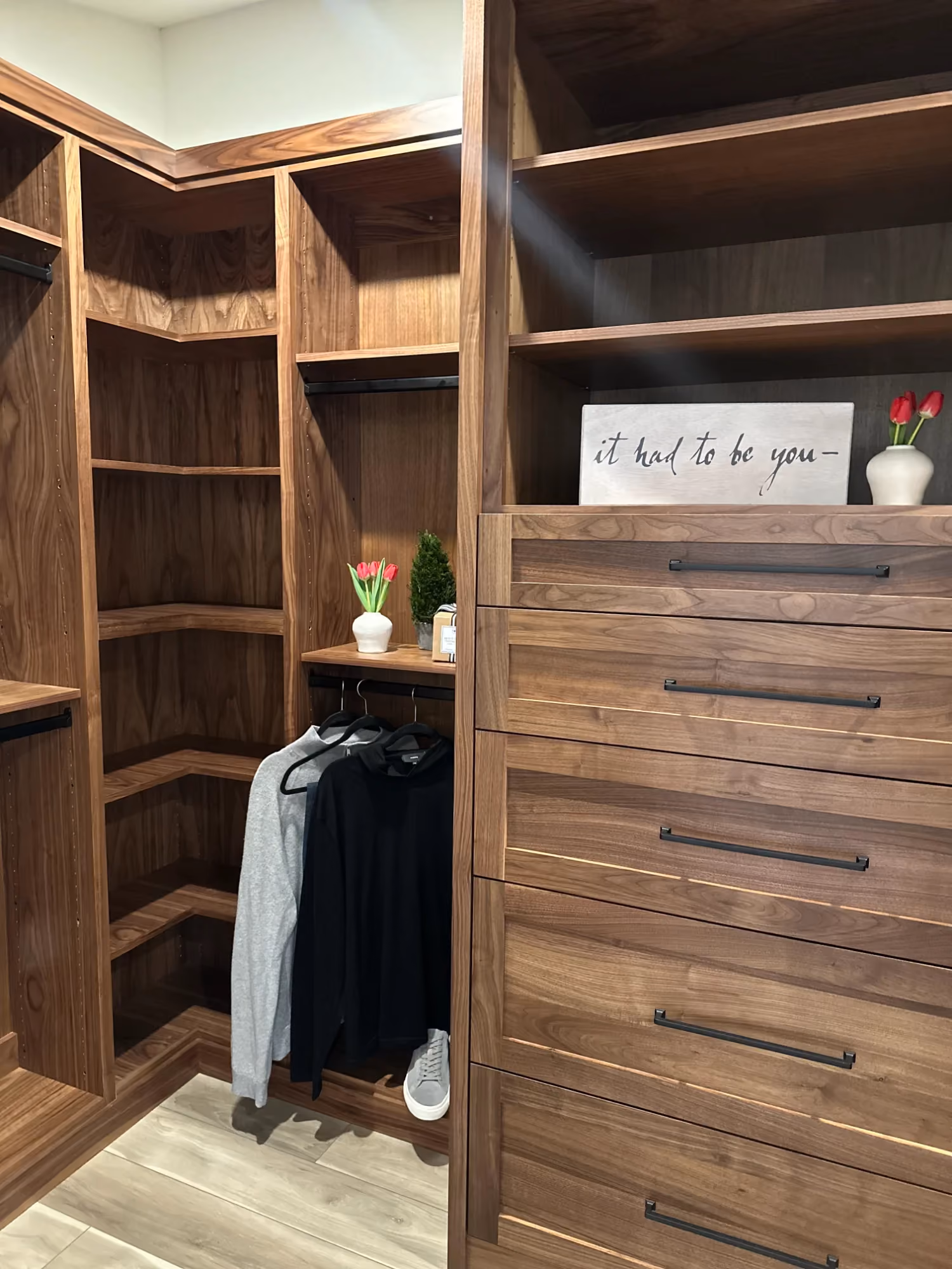 Walk-in closet with wood drawers and hanging rods