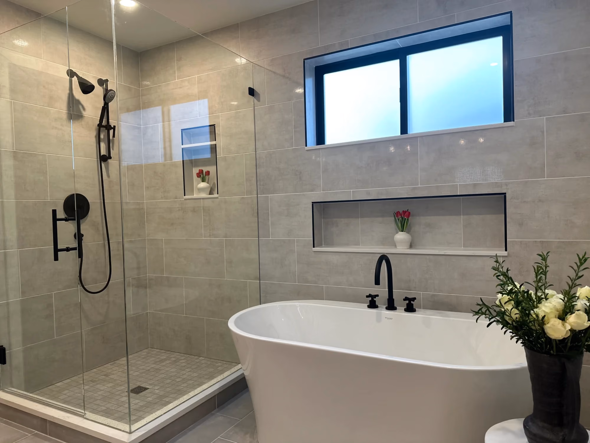 Bright bathroom with tub, walk-in shower, and window