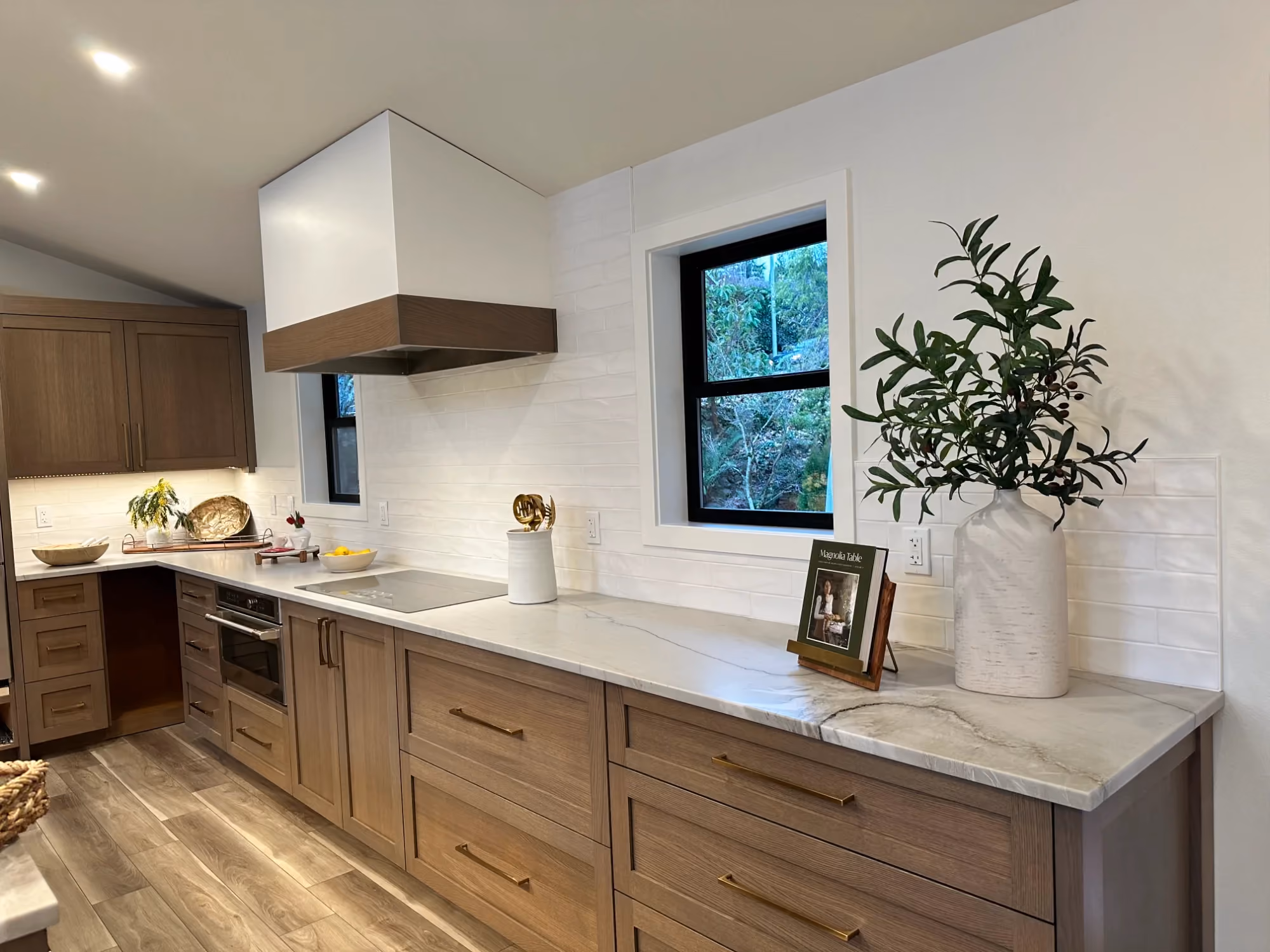 Double-sink vanity with wooden cabinets and large mirror