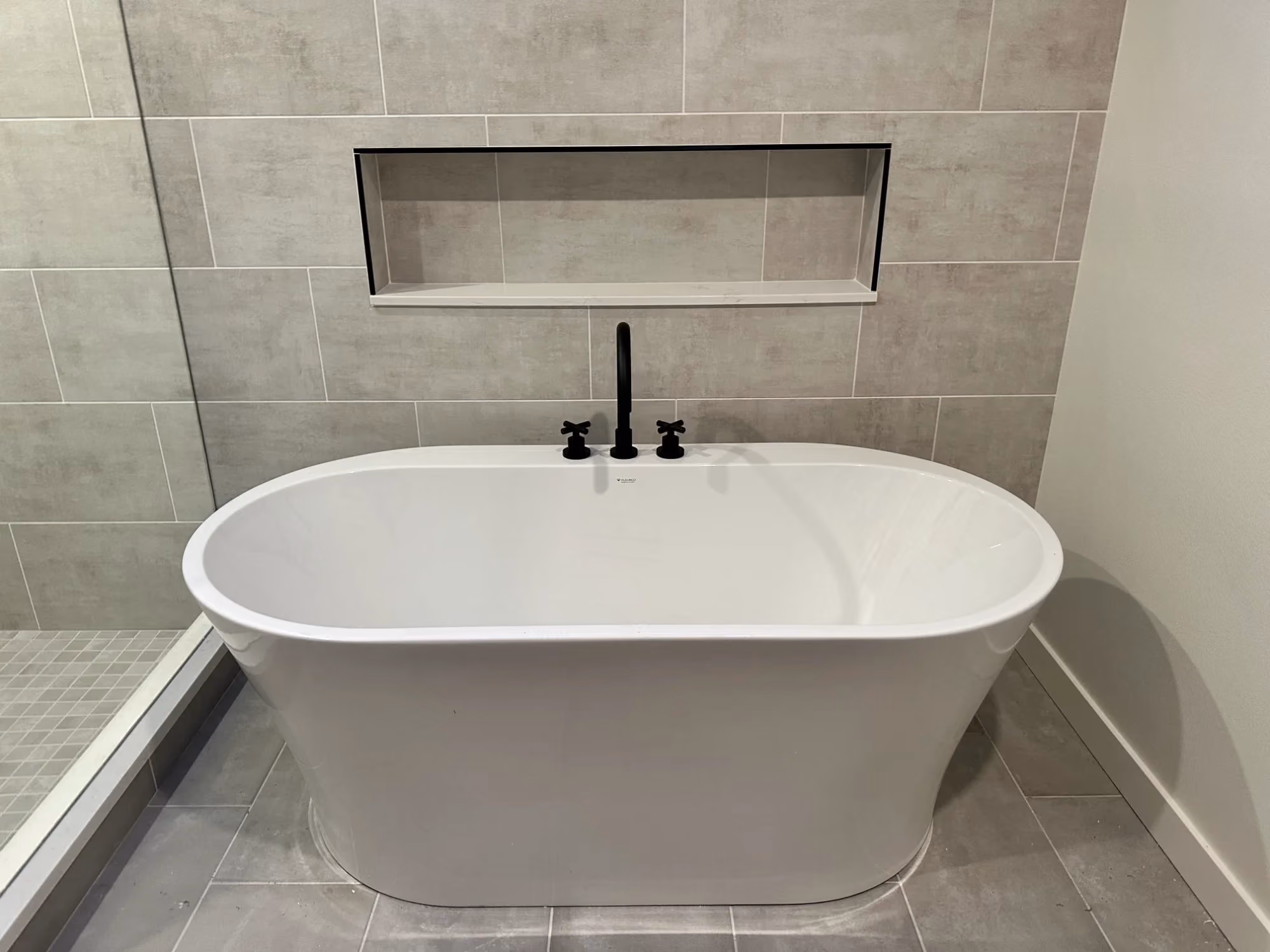 Modern freestanding bathtub with wall-mounted faucet